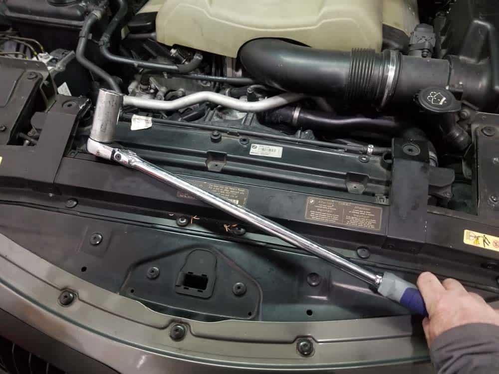 bmw e63 belt replacement - Use a long socket wrench to turn the crankshaft pulley bolt.
