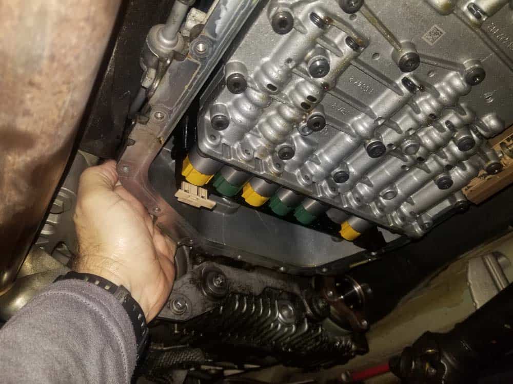 BMW mechatronics sealing sleeve and adapter replacement - Reach behind the transmission and find the electrical plug