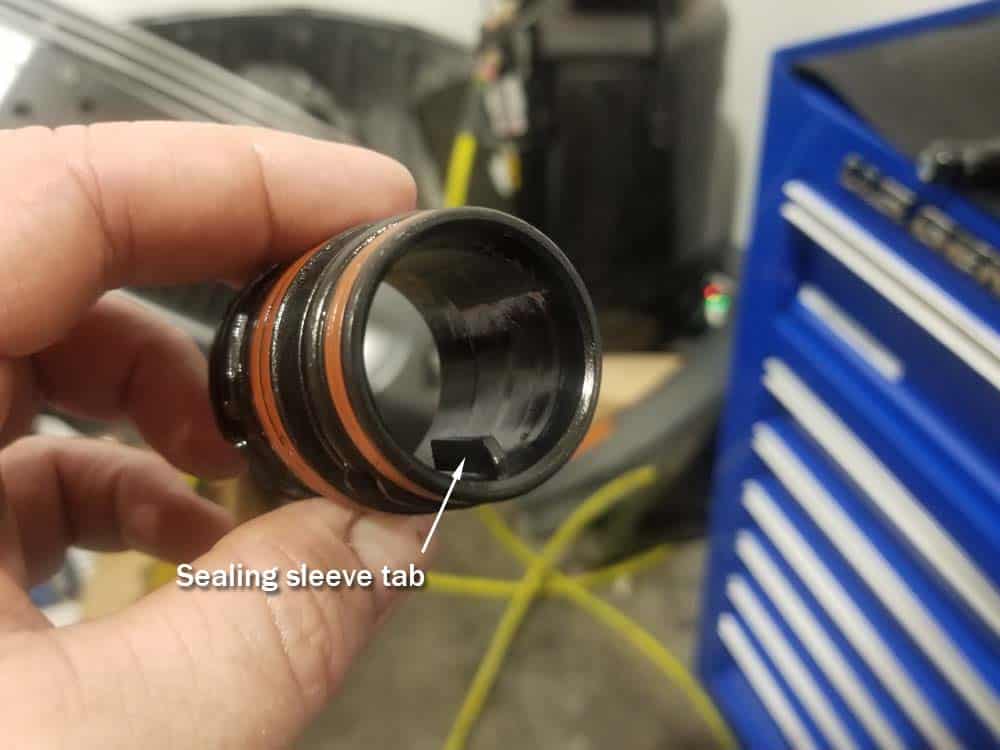 BMW mechatronics sealing sleeve and adapter replacement - sealing sleeve tab.