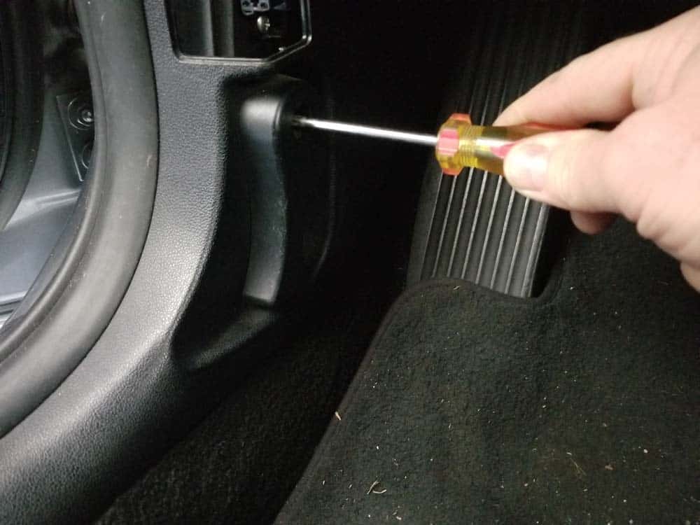 Remove the hood release handle with a phillips screwdriver