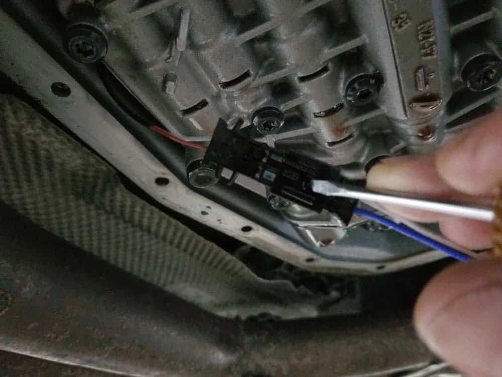BMW 5HP19 solenoid replacement - Depress the locking tab on the speed sensor connection with a small flat blade screwdriver