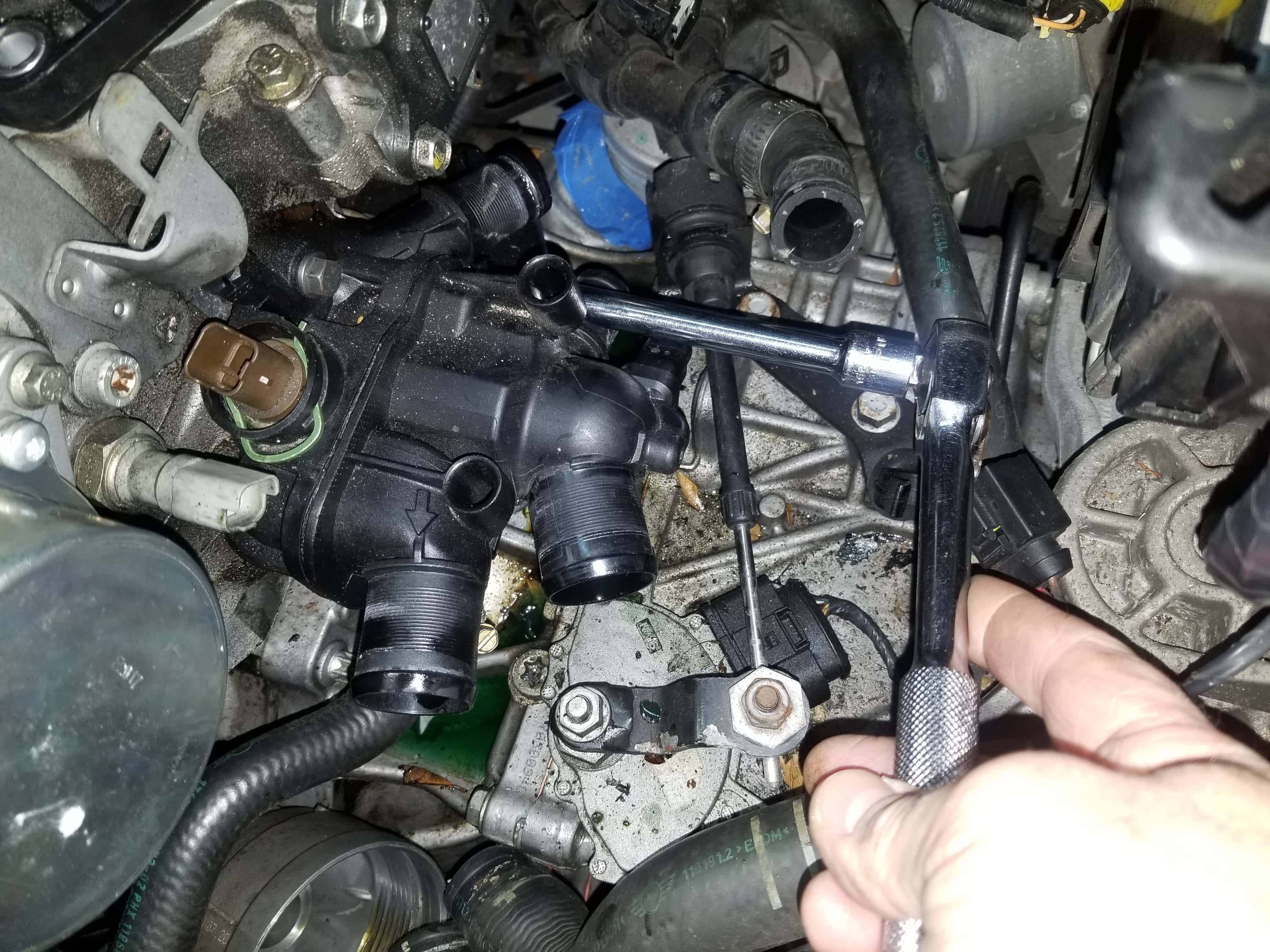 Mini R56 water pipe replacement - Remove the thermostat mounting bolts
