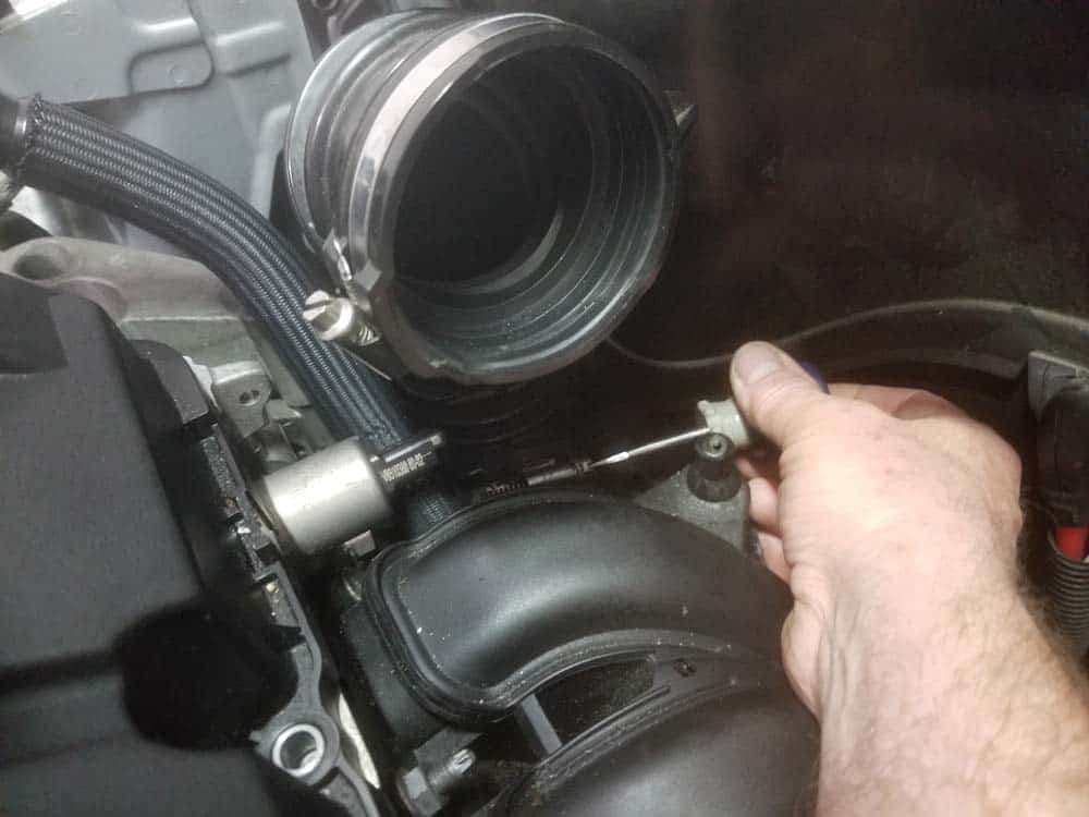 MINI R56 intake gasket repair - Loosen the hose clamp securing the rubber intake boot to the throttle body.