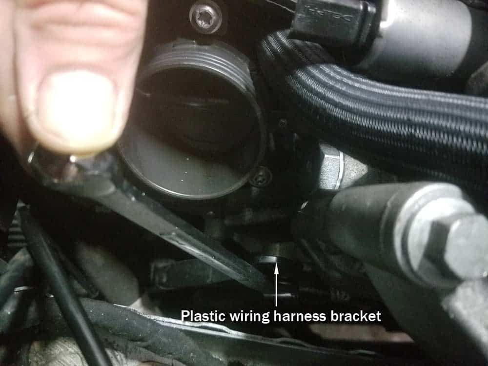 MINI R56 intake gasket repair - Loosen the plastic wiring harness bracket below the throttle body.