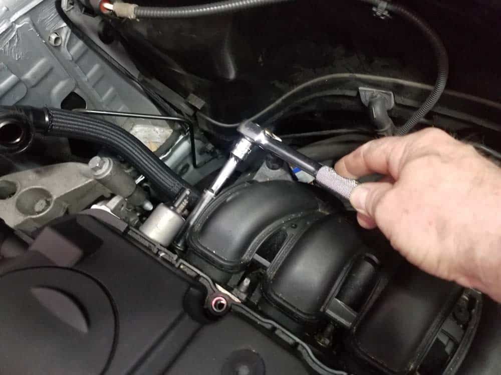 MINI R56 water pipe replacement - Remove the five upper intake manifold mounting nuts.
