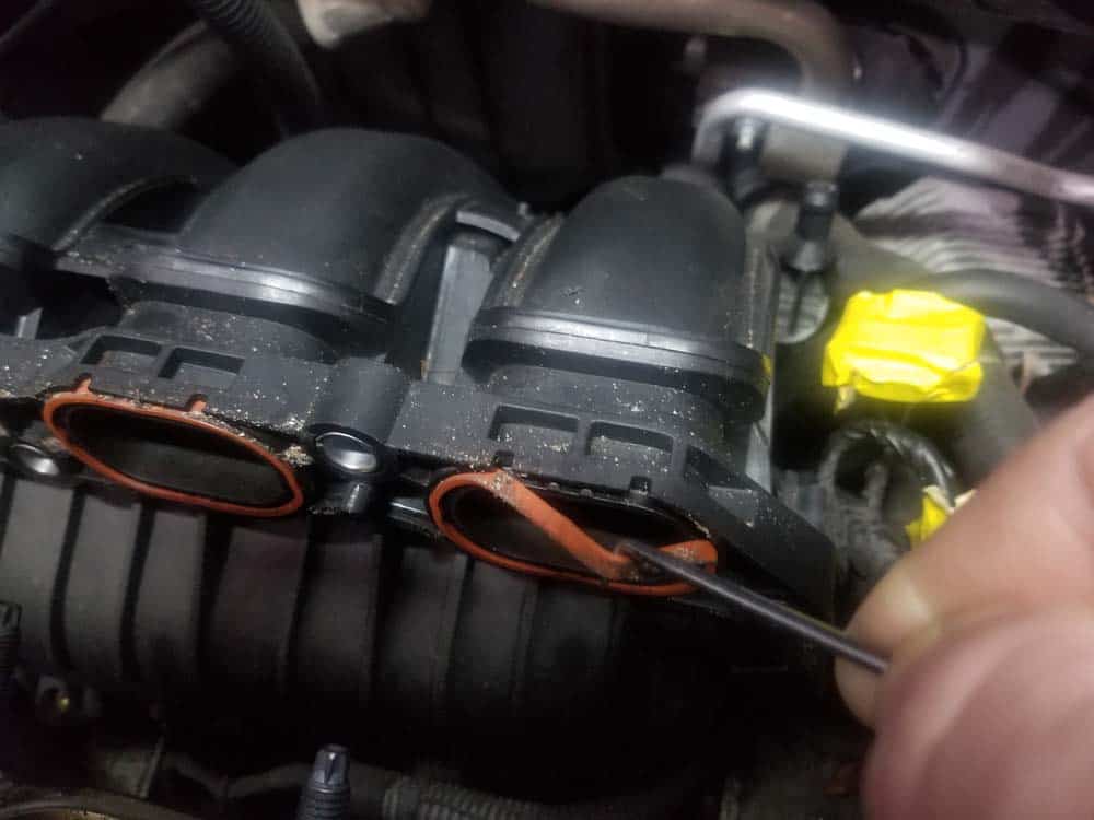 MINI R56 intake gasket repair - Use a pick to remove the old intake manifold gaskets