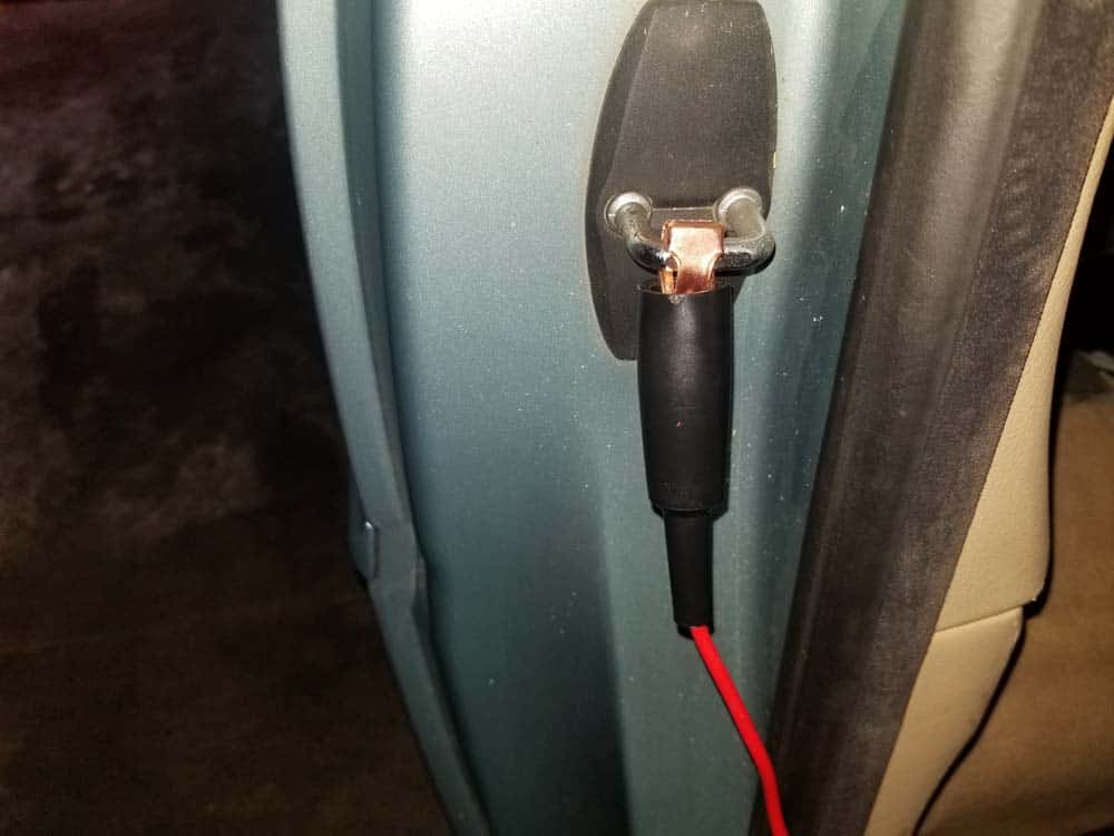 Use the door catch as a ground for your test light or multimeter