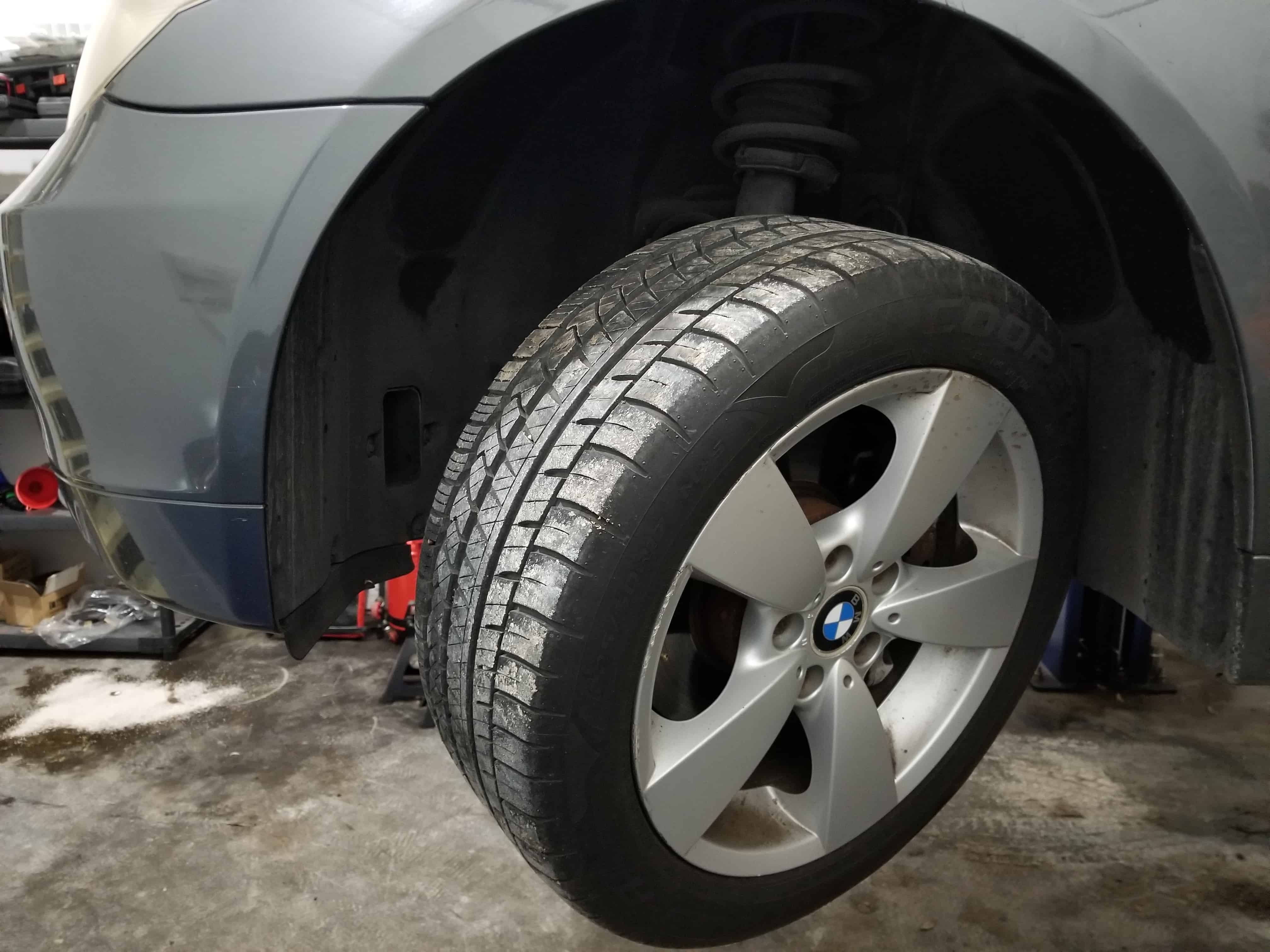 bmw e60 windshield washer pump replacement - rotate the front left wheel out so the front fender liner can be removed