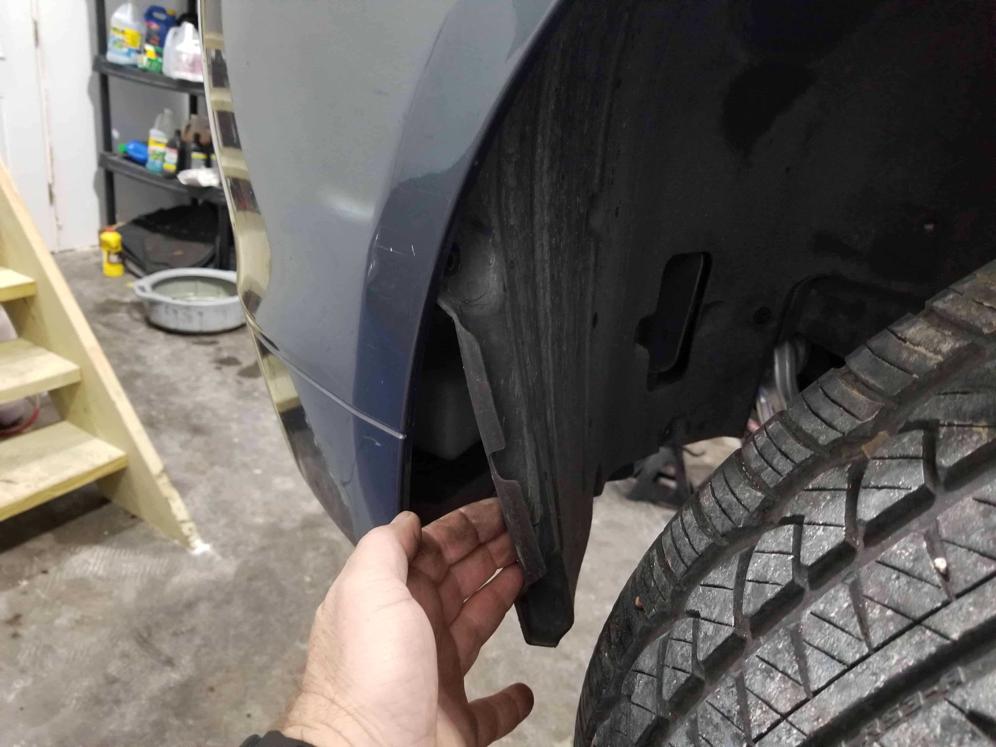 Pull the fender liner free from the car after the screws are removed.