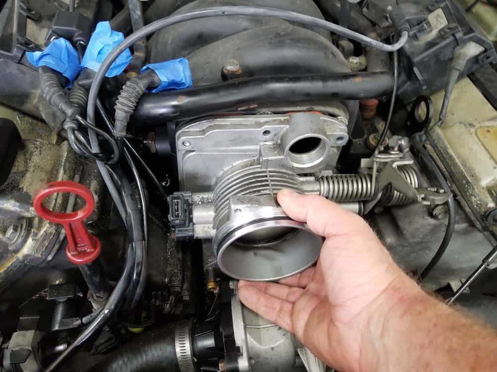 Grasp the throttle body and remove from the intake manifold