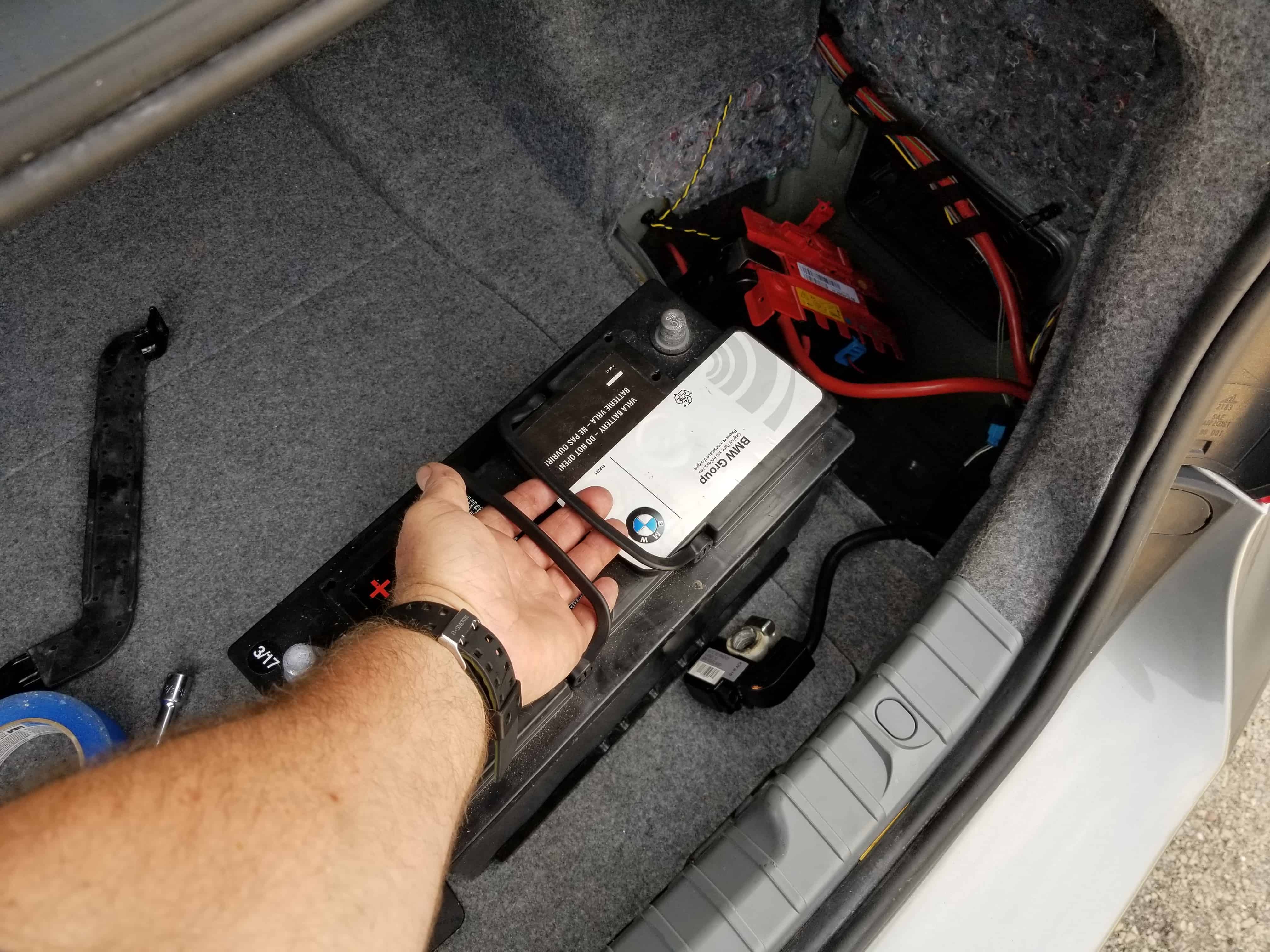 bmw e90 battery replacement - Grasp the battery and remove it from the trunk