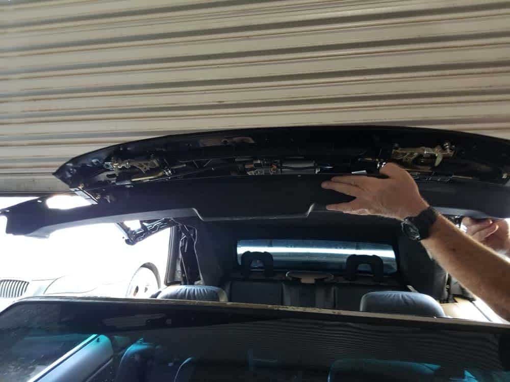 Remove the windshield frame cover from the convertible top.