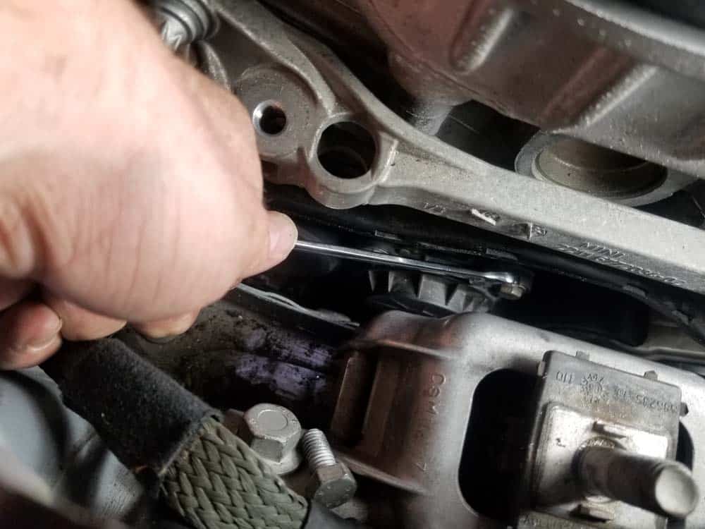 Use an open end wrench to turn the upper bolts all the way in so a torque wrench will fit on them.
