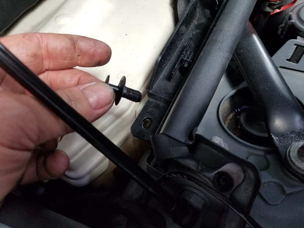 Remove the right plastic rivet from the lower cabin filter housing