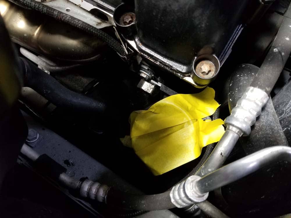 Seal off the lower intake duct with tape to keep debris from falling into the turbo charger