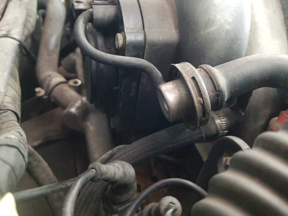 The fuel return line. Usually its best to wait until the intake manifold is removed to disconnect it.