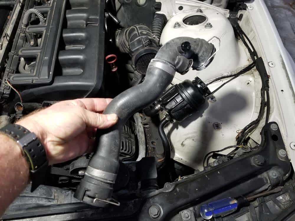 Remove the upper radiator hose from the vehicle