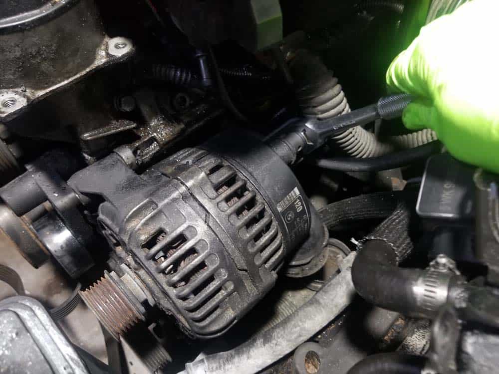 bmw e46 alternator replacement - Use a 13mm socket wrench to remove the positive battery cable nut
