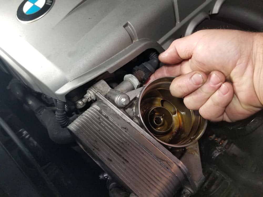 bmw n52 oil filter housing gasket replacement - Depress the metal release clip on the oil pressure sensor plug