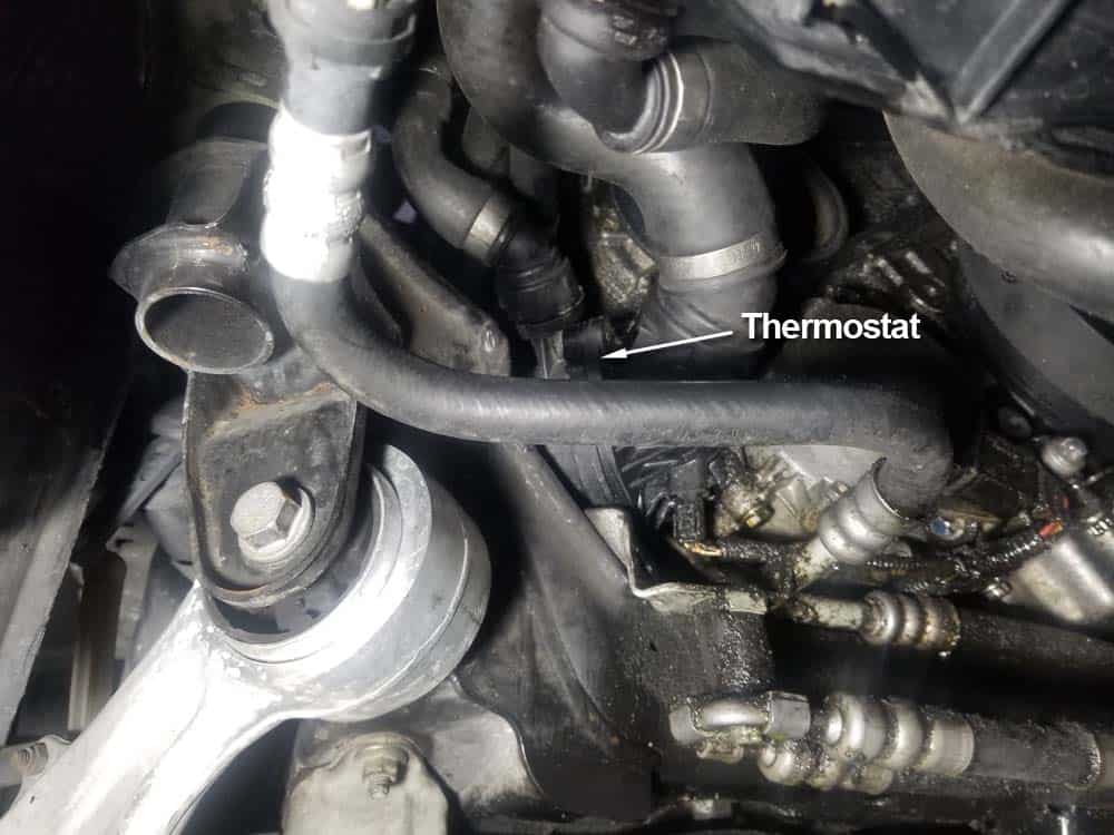 bmw e60 coolant flush - Locate the thermostat on the front left side of the engine 