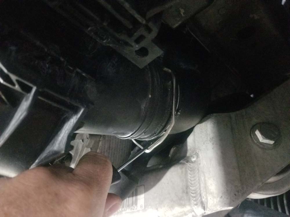 bmw e90 thermostat replacement - release the charge tube locking clips