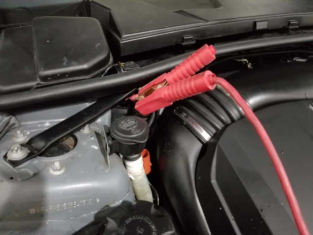 bmw e90 thermostat replacement - attach the battery cables to the engine compartment terminals