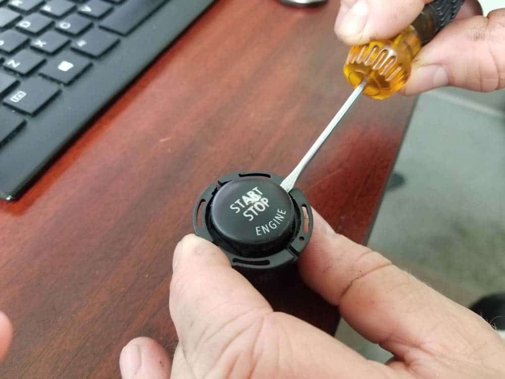 bmw e60 start button replacement - pry the start button out of the housing with a flat blade screwdriver