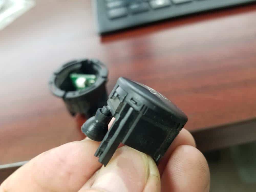 bmw e90 start button replacement - locate the plastic retaining clips on the side of the button