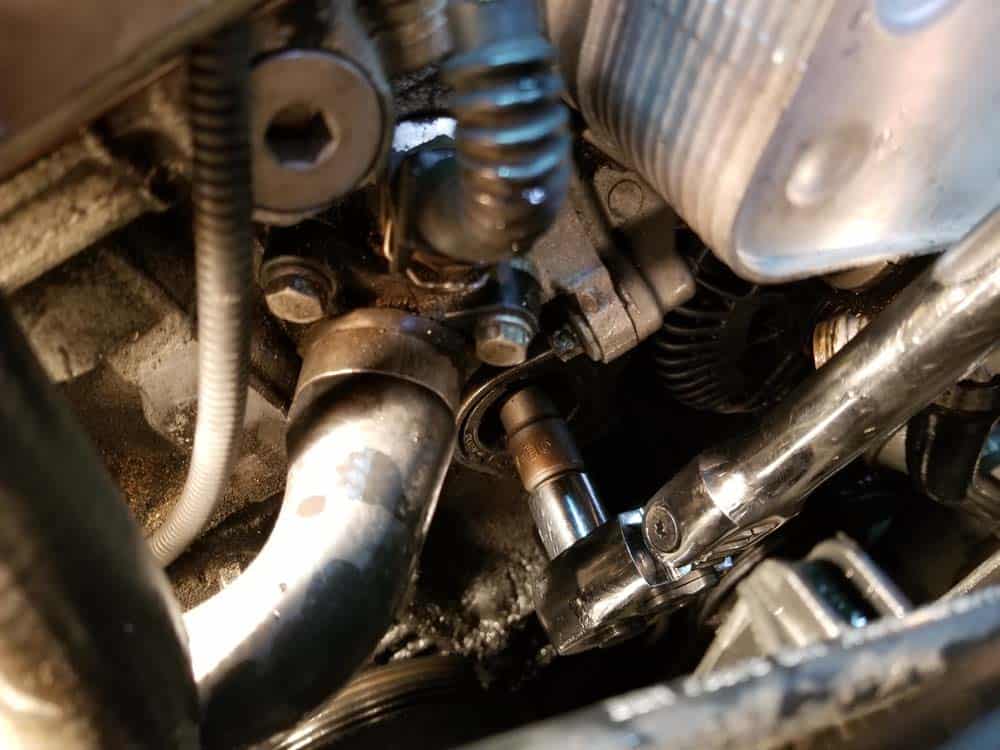 Remove the tensioner pulley bolt with an E16 socket