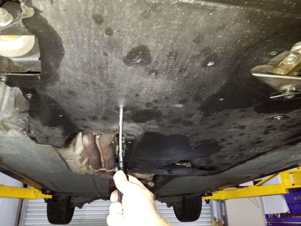 bmw e60 thermostat replacement - Remove the rear belly pan from underneath the vehicle