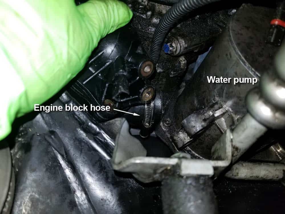 bmw e60 water pump replacement - locate the engine block coolant hose on the back of the water pump