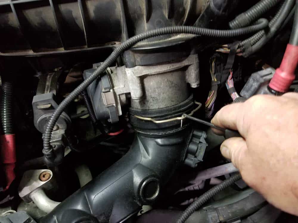 Release the locking clip where the charge pipe attached to the throttle body