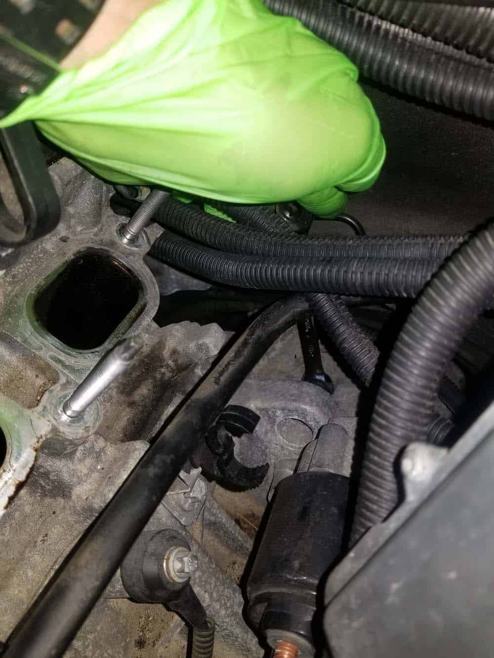 Remove the upper mounting bolt