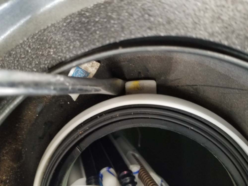 bmw e60 fuel pump replacement - Use a flat blade screwdriver to wedge the adapter ring so it doesn't spin
