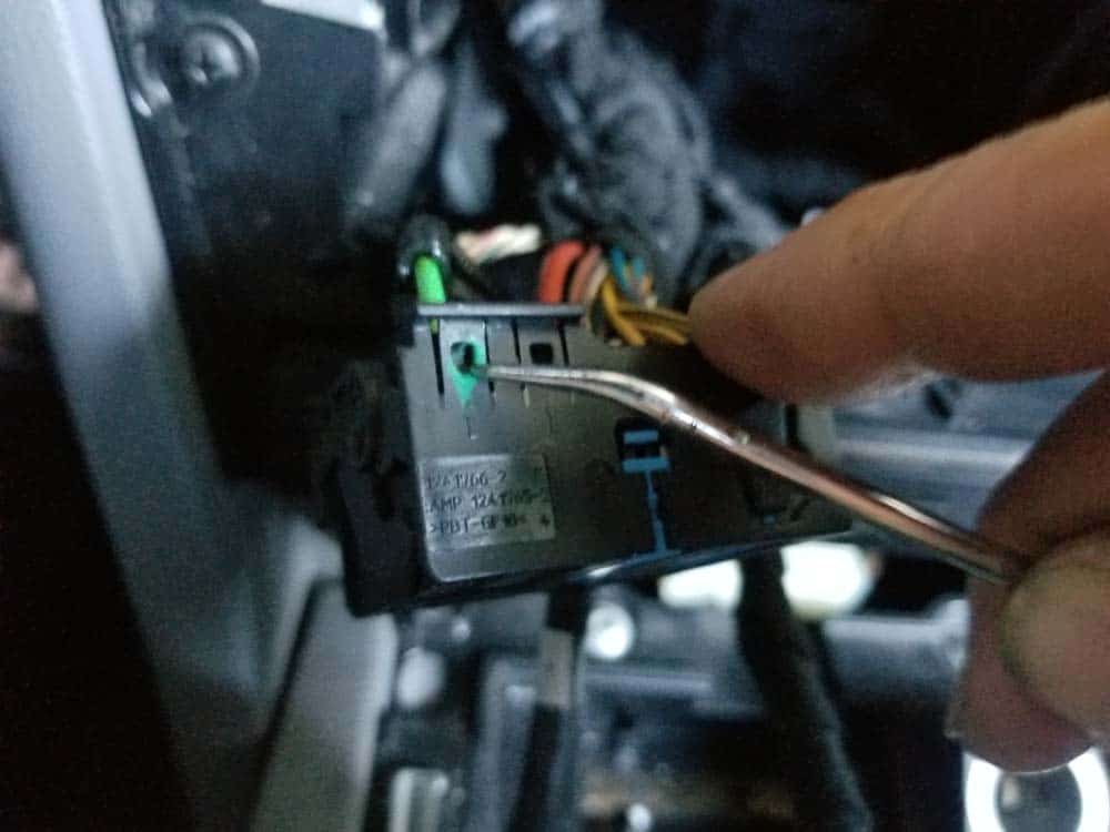 Use a metal pick or small flat blade screwdriver to release the fiber optic plug.