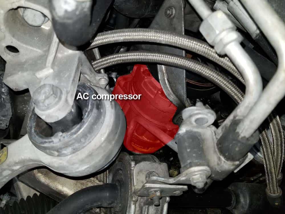 Locate the AC compressor under the vehicle