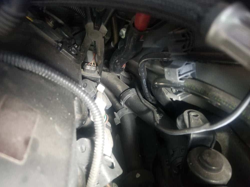 Gently squeeze the exhaust camshaft sensor plugs locking tabs with a pair of longnose pliers