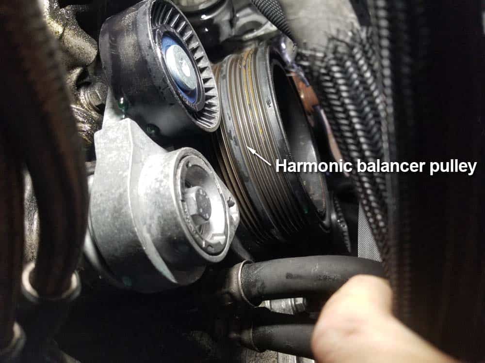 Remove the ac belt from the ac compressor and the harmonic balancer pulley