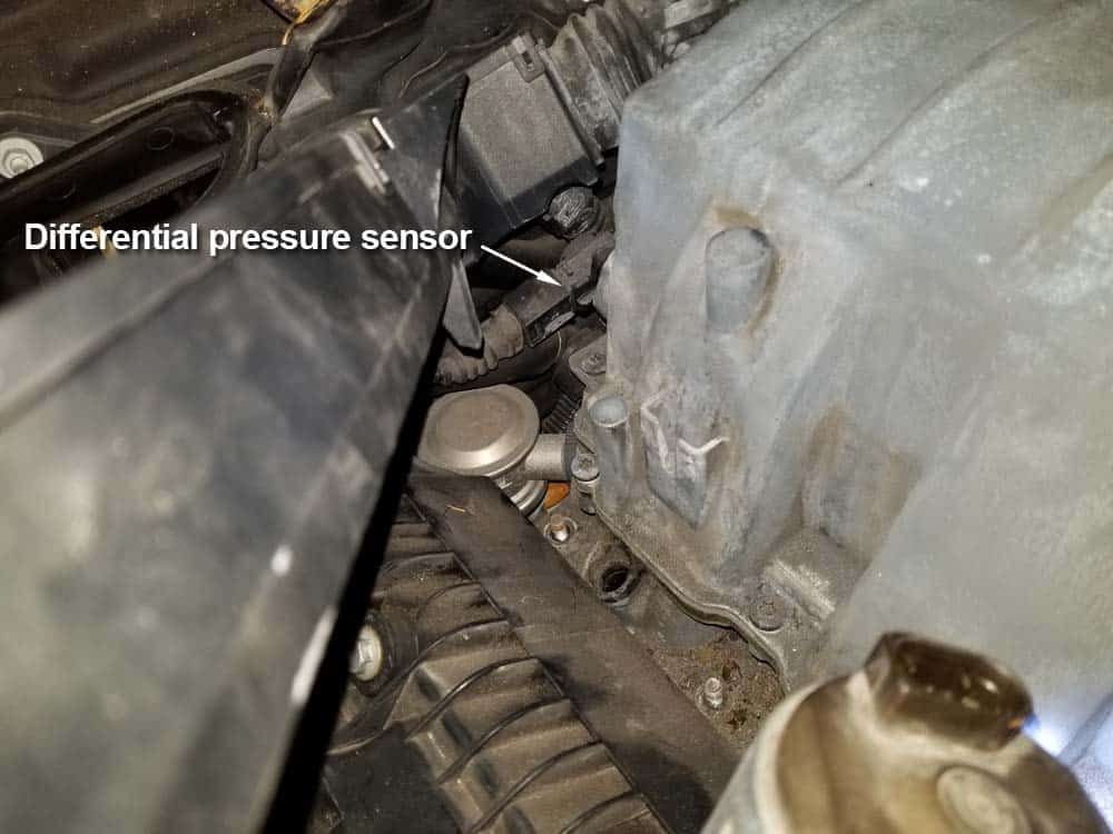 Locate the differential pressure sensor on the back right side of the intake manifold