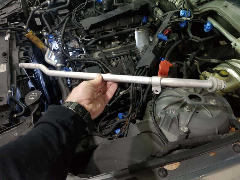 bmw n62 valley pan replacement - Remove the heater return line from the vehicle