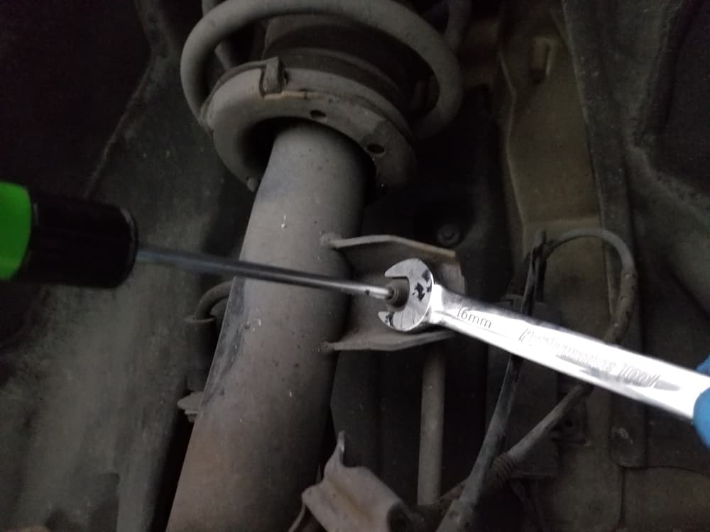Use a 16mm open end wrench and T30 Torx bit to remove the sway bar link nut