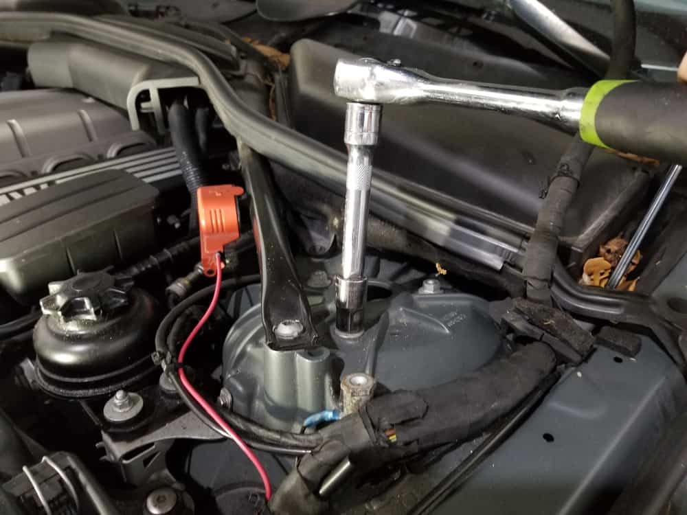 bmw e60 front strut replacement - Use a 15mm socket wrench to remove the three strut mount nuts