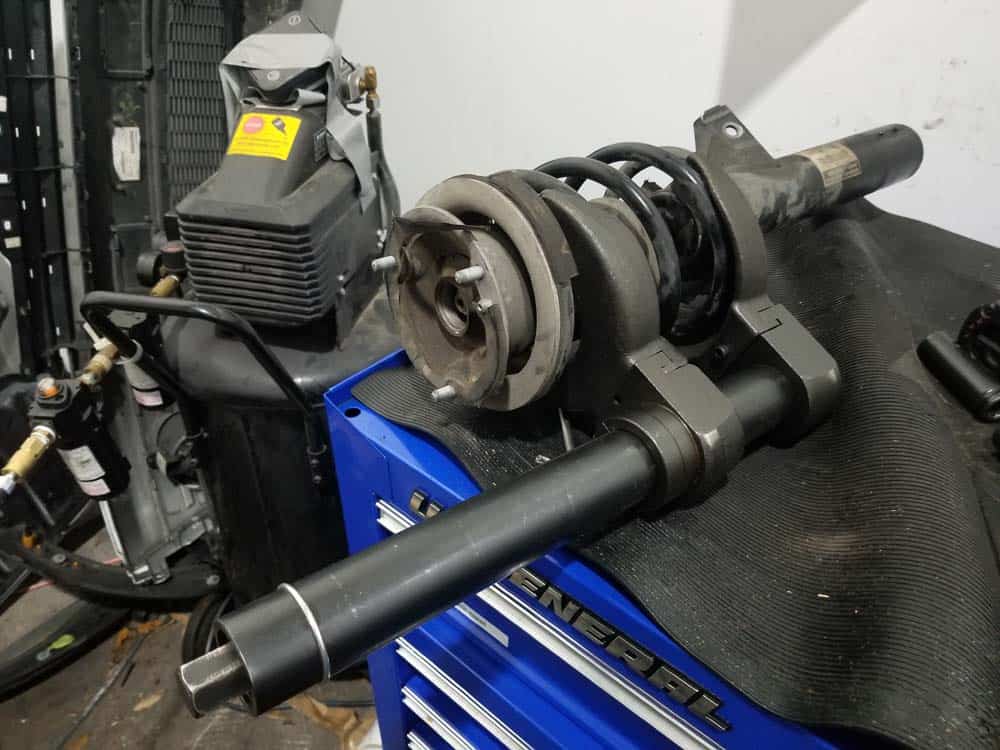 bmw e60 front strut replacement - Use a plate style spring compressor to compress the spring